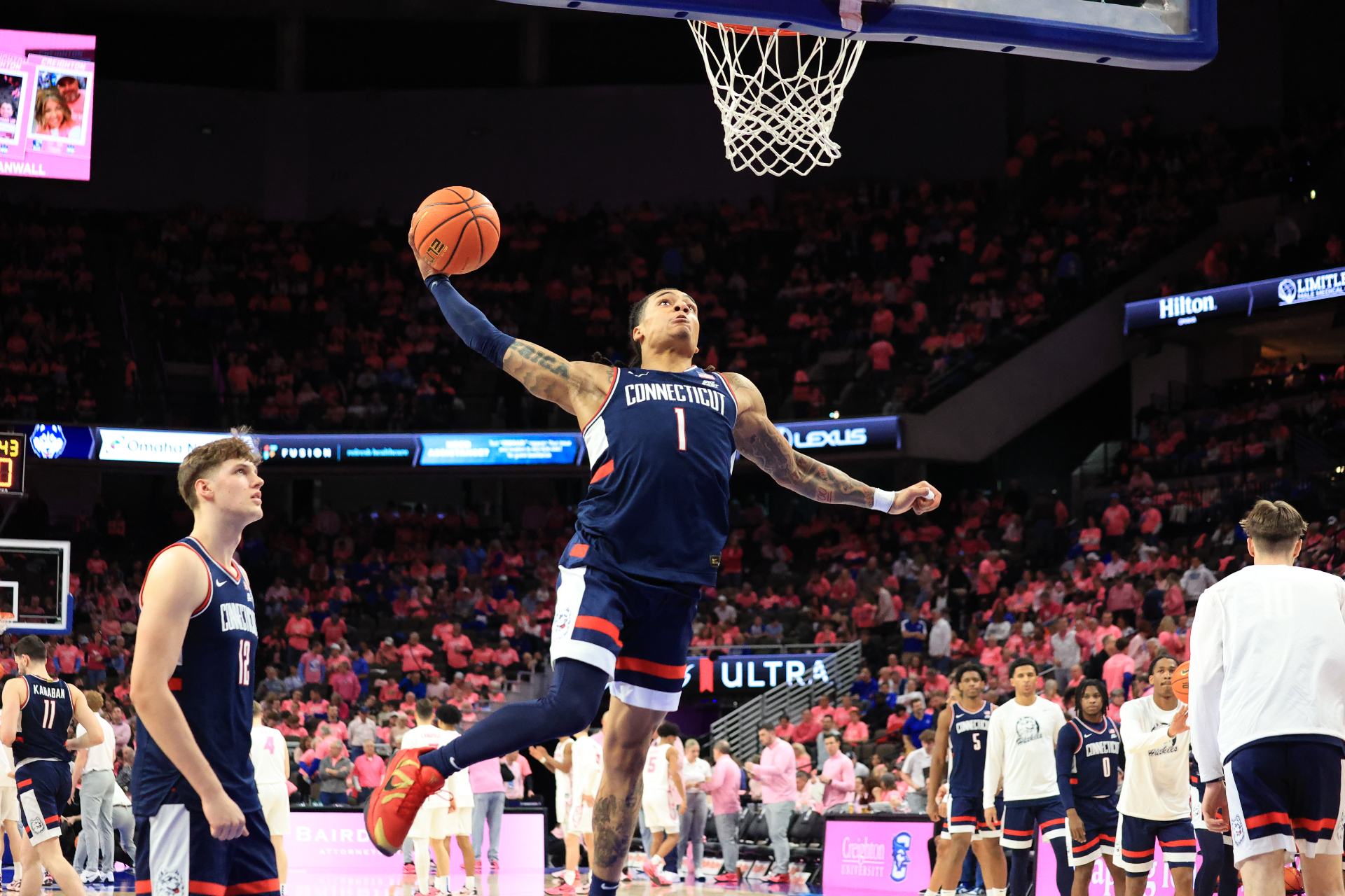 UConn player rising for a warm-up dunk