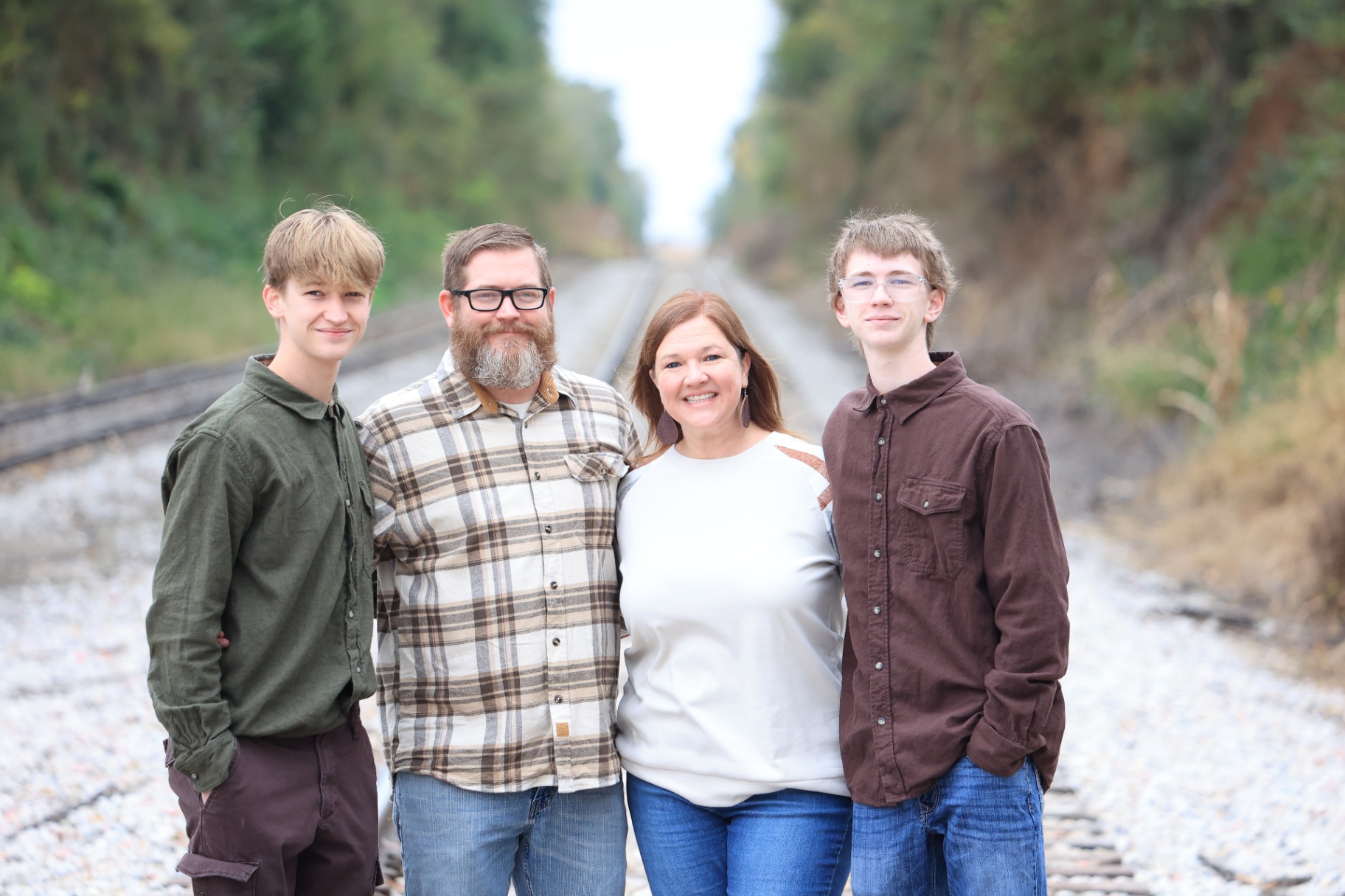 Family of four on train tracks